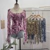 Horn long sleeved T-shirt with irregular ruffle edge and ribbon top